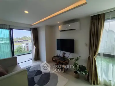 Modern living room with large windows and stylish decor, featuring a wall-mounted TV and air conditioning.