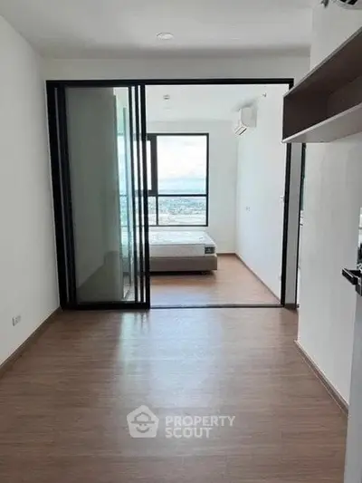 Modern apartment with sliding glass doors and a scenic view from the bedroom.