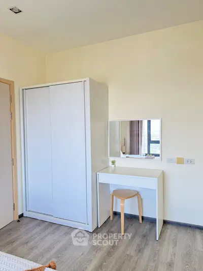 Modern bedroom with sleek white wardrobe and minimalist vanity set