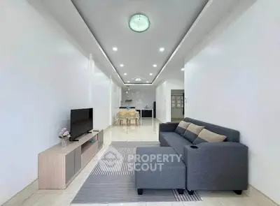 Spacious modern living room with sleek furniture and open layout, perfect for contemporary living.