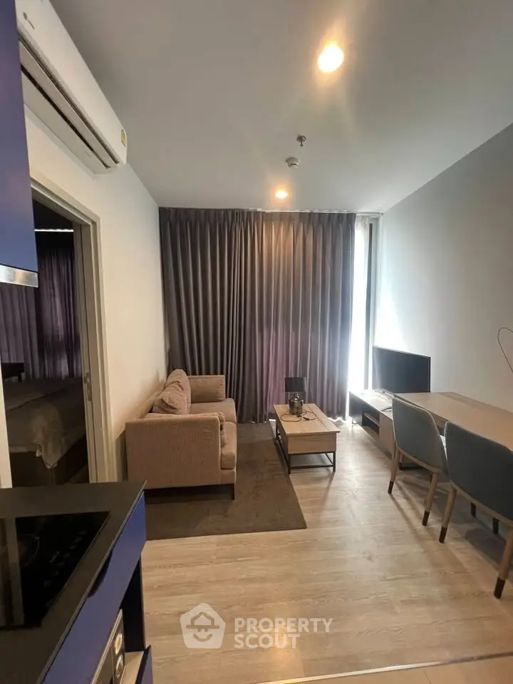 Modern living room with cozy sofa and dining area in stylish apartment.