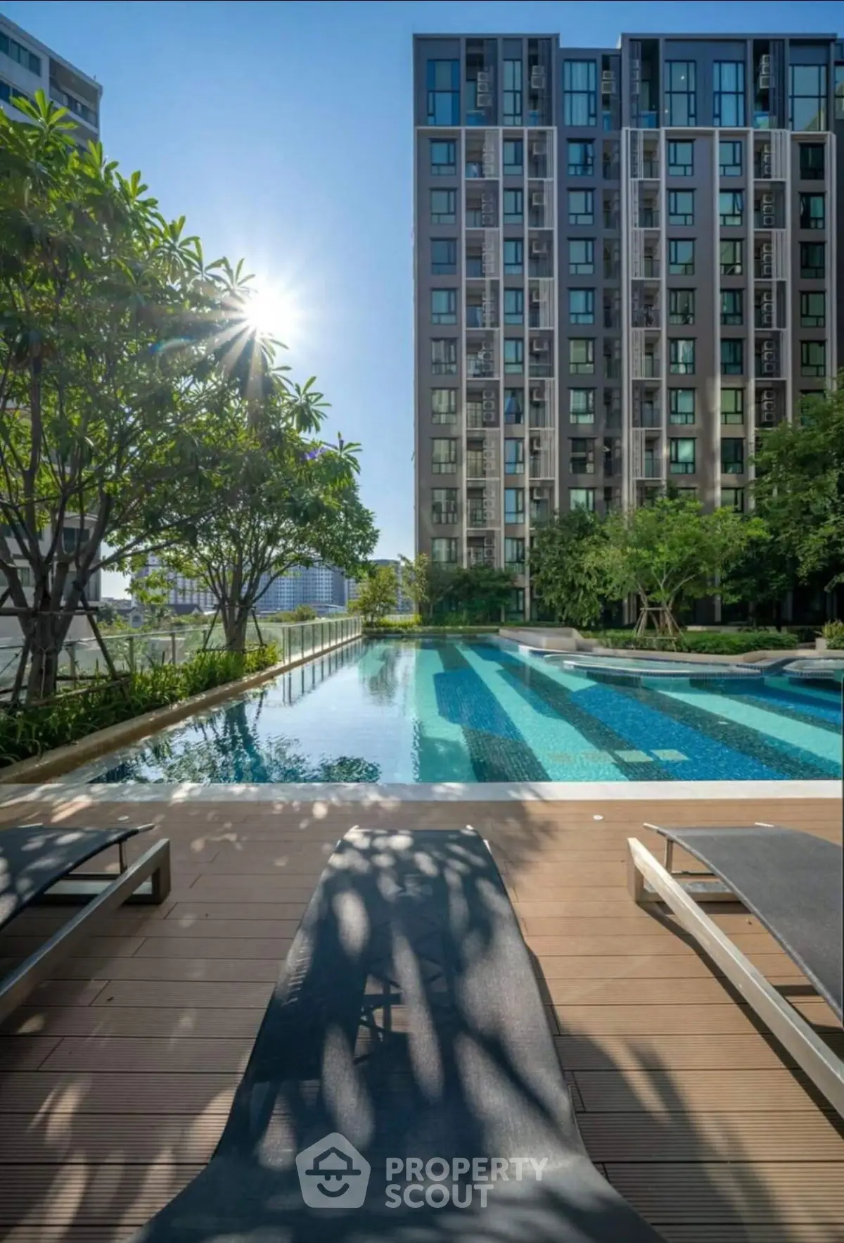 Luxurious condominium with stunning pool and lush greenery, perfect for relaxation and leisure.