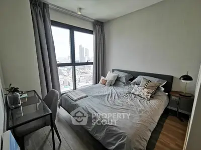 Modern bedroom with city view, featuring a cozy bed and stylish decor in a high-rise apartment.