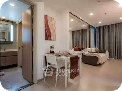 Modern open-plan living room with dining area and stylish decor in a contemporary apartment.