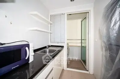 Compact kitchen with modern appliances and sleek design