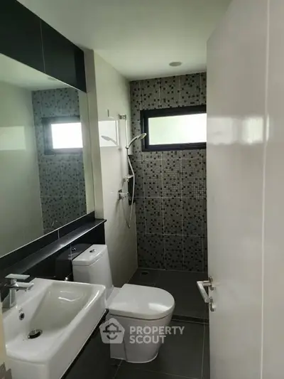 Modern bathroom with sleek fixtures and stylish tile design.