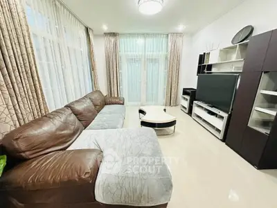 Spacious living room with modern furniture and large windows for natural light.