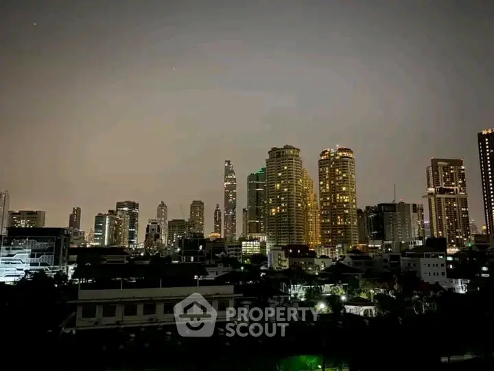 Stunning city skyline view with illuminated skyscrapers at night, perfect for urban living enthusiasts.
