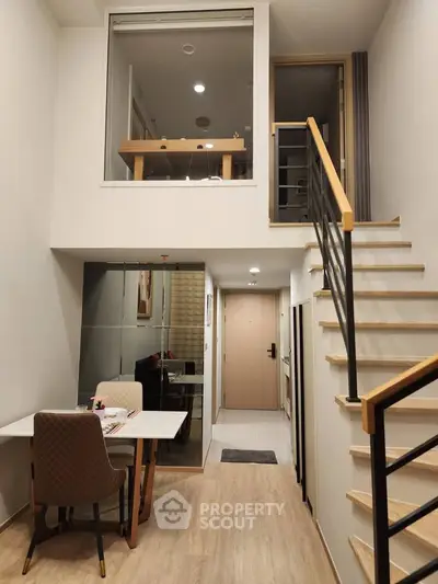 Modern duplex apartment with stylish staircase and cozy dining area