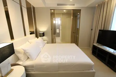 Luxurious modern bedroom with elegant decor and ensuite bathroom in a high-end apartment.
