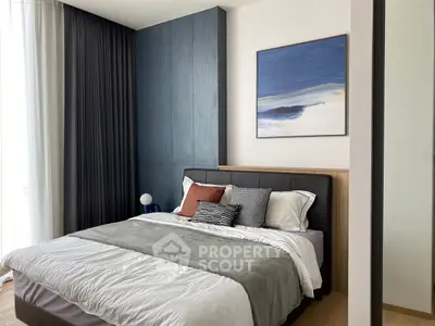 Modern bedroom with stylish decor and cozy bedding in a contemporary apartment.