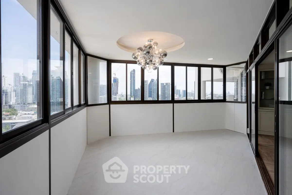 Spacious corner unit with panoramic city views and elegant lighting.