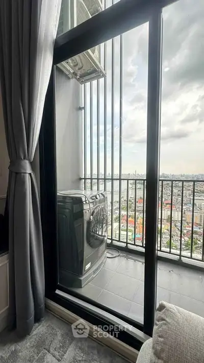 High-rise apartment balcony with city view and washing machine, perfect for urban living.