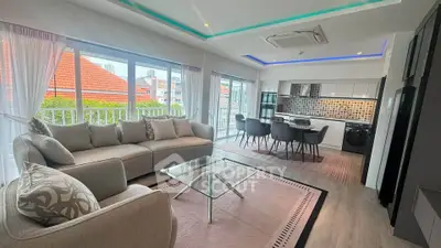 Modern open-plan living room with stylish kitchen and large windows