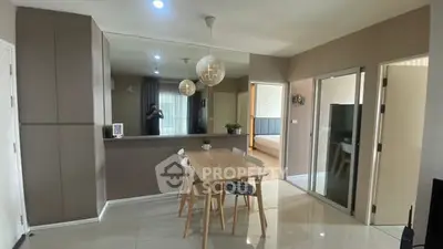 Modern dining area with sleek design and neutral tones in a contemporary apartment.