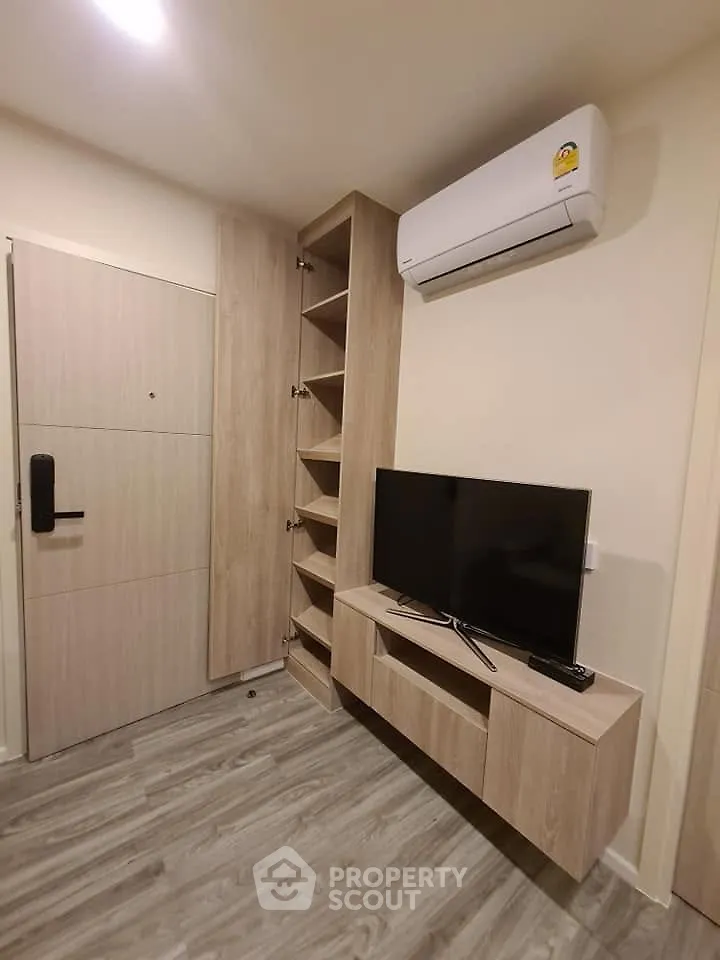 Modern living room with sleek TV unit and air conditioning