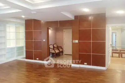 Spacious modern living room with wooden flooring and elegant wall design