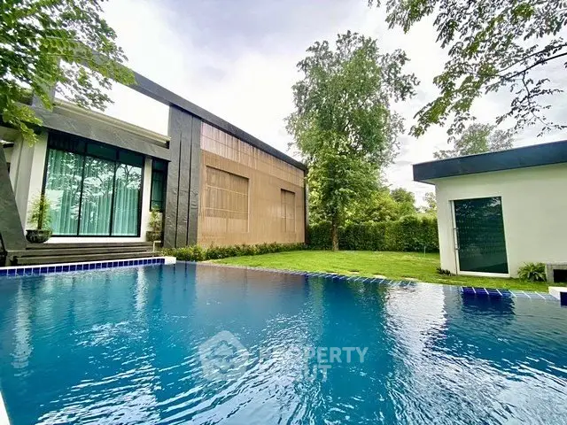 Luxurious modern home with stunning pool and lush garden view