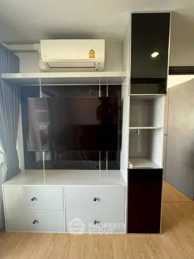 Modern living room with sleek TV unit and air conditioning, perfect for contemporary urban living.