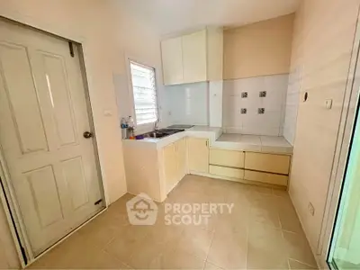 Cozy kitchen with closed layout and ample storage space, perfect for culinary enthusiasts.
