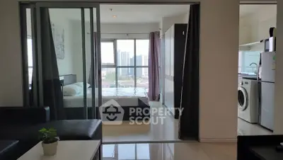 Modern apartment interior with bedroom, kitchen, and city view.