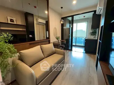 Modern living room with balcony view and stylish decor in urban apartment.