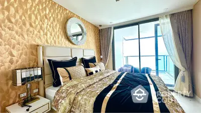 Luxurious bedroom with elegant decor and balcony view in modern apartment.