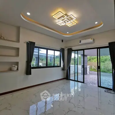 Spacious modern living room with elegant lighting and large windows