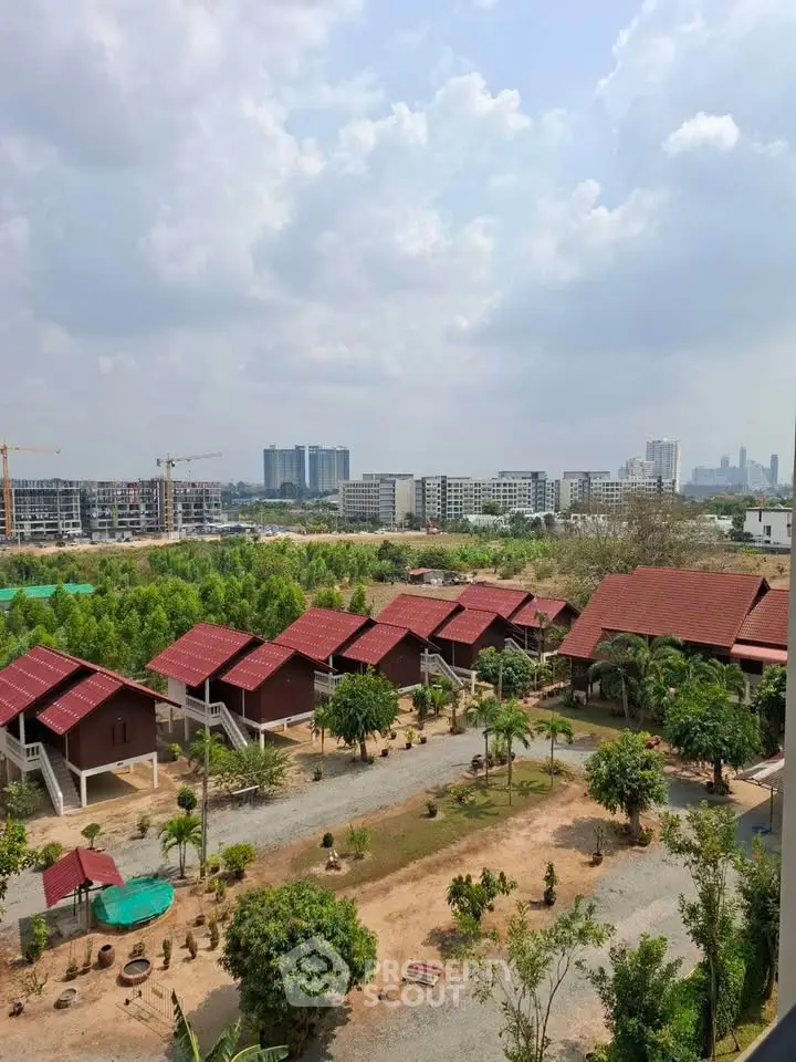 Scenic aerial view of residential area with red-roofed houses and lush greenery