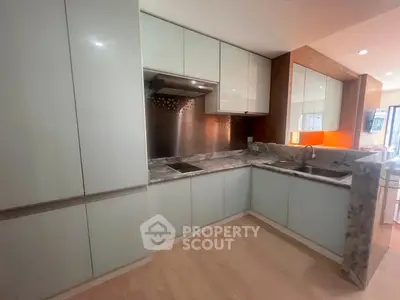 Modern kitchen with sleek cabinetry and marble countertops