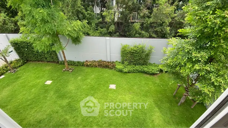 Lush green garden view from a high vantage point, perfect for relaxation and outdoor activities.