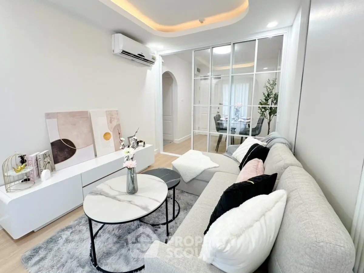 Stylish modern living room with cozy gray sofa and chic decor