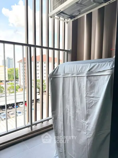 Charming balcony with laundry area and city view, perfect for urban living.