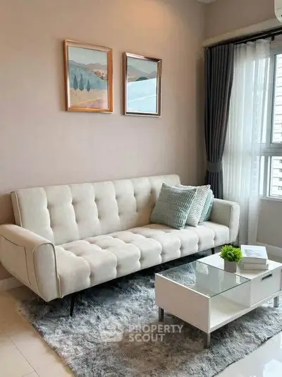 Chic living room with modern sofa, stylish decor, and natural light