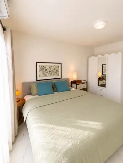 Cozy bedroom with modern decor and ample natural light