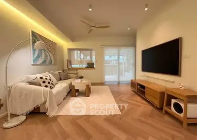 Modern living room with stylish decor and large TV