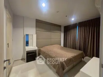 Spacious modern bedroom with elegant decor and ample natural light