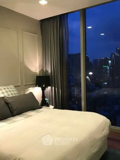 Luxurious bedroom with city skyline view, featuring elegant decor and large windows for natural light.