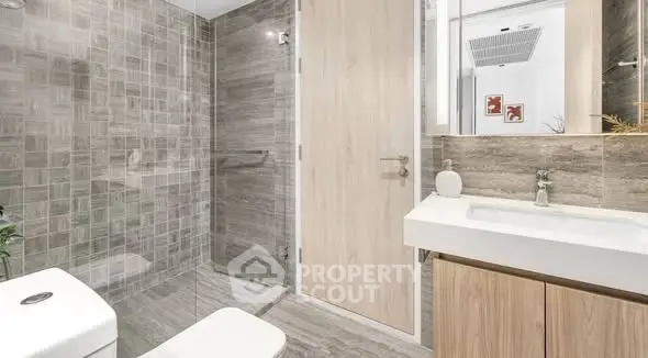 Modern bathroom with sleek design and glass shower enclosure.