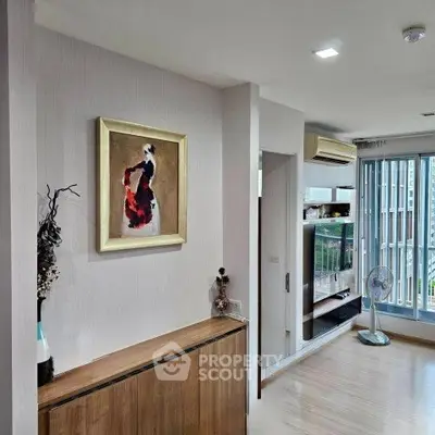 Modern living room with stylish decor and balcony access, featuring sleek wooden furniture and contemporary art.