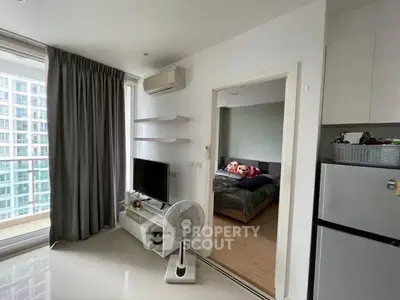 Modern apartment with cozy bedroom and sleek living area, featuring large windows and contemporary furnishings.