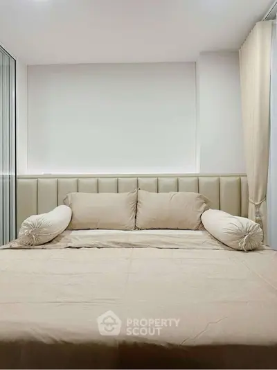 Luxurious bedroom with plush bedding and elegant neutral tones.