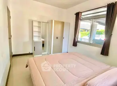 Bright and cozy bedroom with large window and modern furniture in a stylish home.