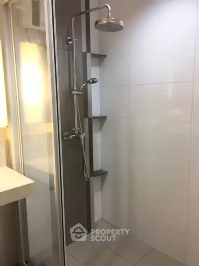 Modern bathroom with sleek shower design and minimalist tiles
