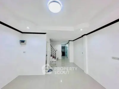 Spacious and bright interior with modern lighting and sleek tile flooring, perfect for customization.