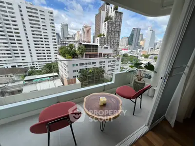 Stylish balcony with city skyline view, featuring modern chairs and a wooden table, perfect for urban living.