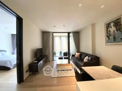 Spacious modern living room with elegant decor and natural light, featuring a cozy seating area and stylish dining space.