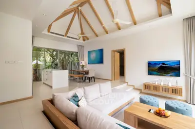 Luxurious open-layout living room with high wooden beam ceiling and modern decor