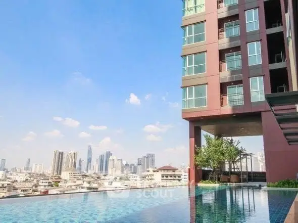 Luxurious high-rise building with stunning rooftop pool and city skyline view.