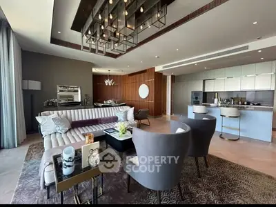 Luxurious modern living room with elegant furniture and open kitchen layout.